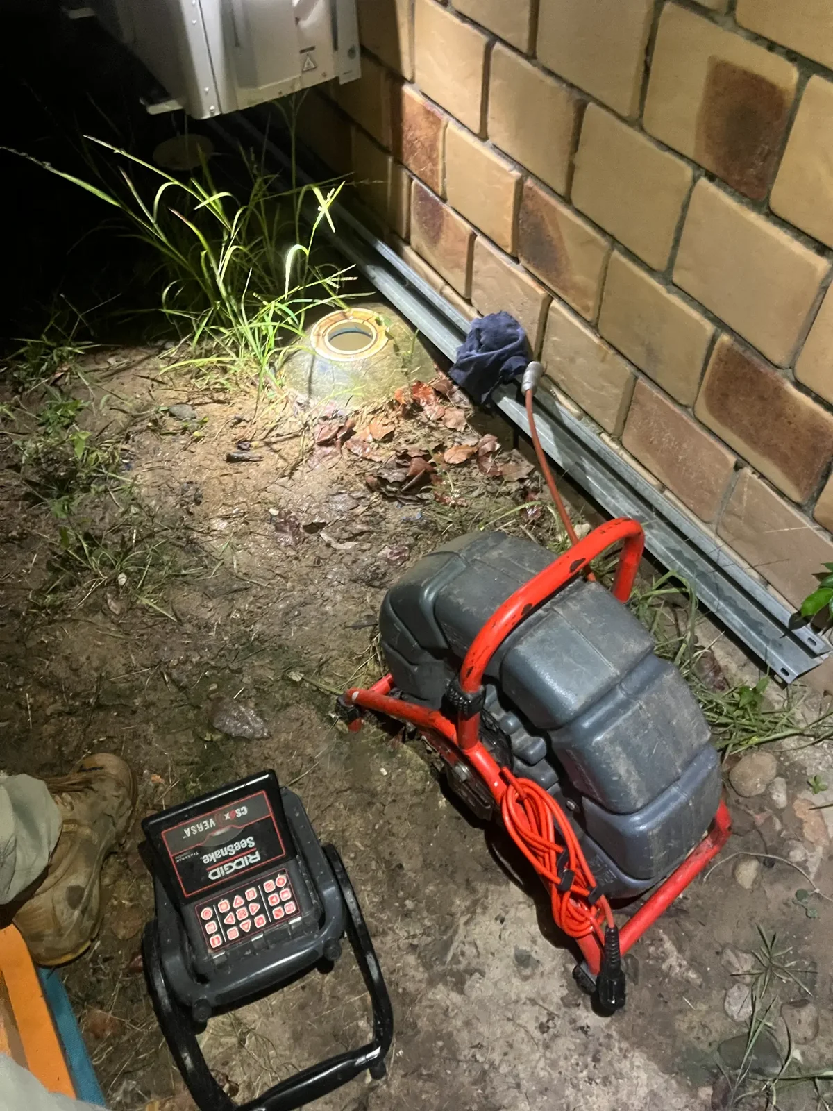 Drain camera at a sewer access during a night emergency callout on the Gold Coast